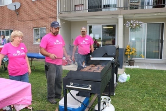 Resident managers barbeque hamburgers