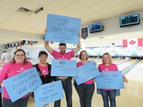 Skyline employees dress up in pink shirts for theme bowling