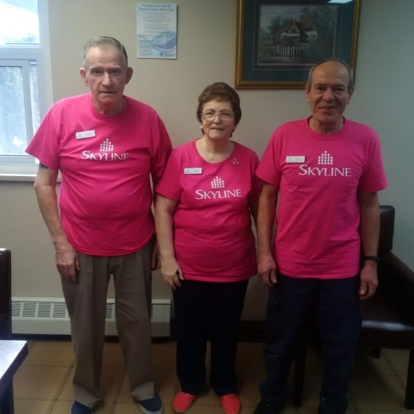 Three site staff in Cambridge, Ontario, wearing pink shirts