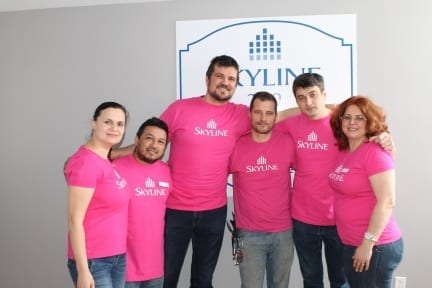 Six resident managers wear pink shirts