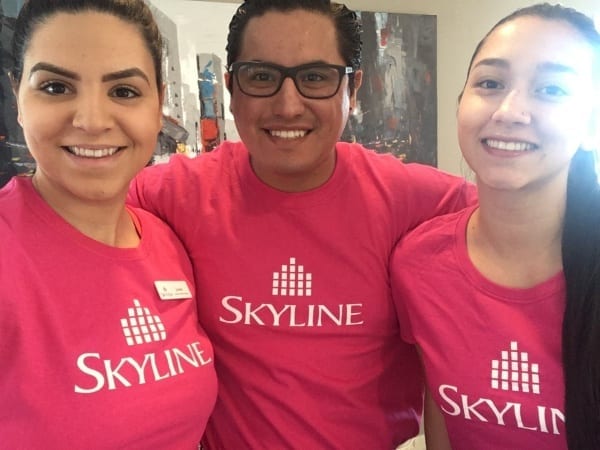 Three site staff in Edmonton, Alberta, wearing pink shirts