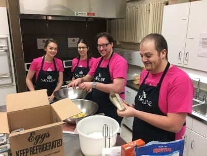 Four Skyliners crack eggs and make pancake batter for Lakeside Hope House