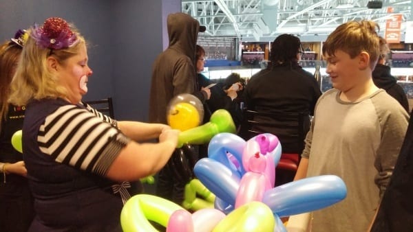 Young child watches a balloon animal being made