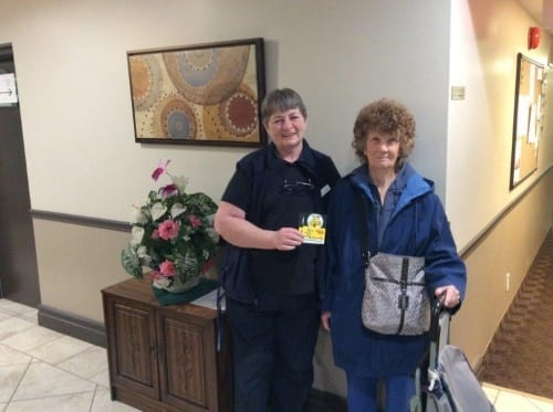 Connie donates a gift card to a resident in need