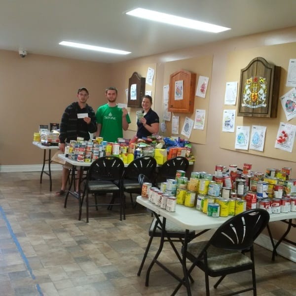 Three tables full of canned good for the food drive