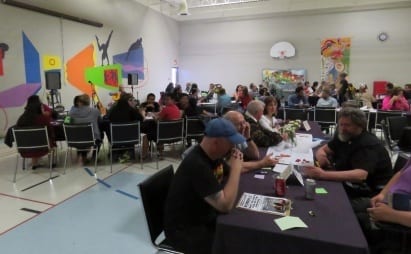 Gymnasium full of volunteers eating dinner