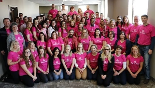 Group of up to fifty Skyline employees at head office wearing Pink Shirts