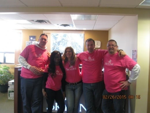 Five Commercial REIT employees wear pink shirts