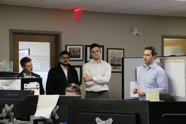 Associate Director of Acquisitions speaks to students in an office setting