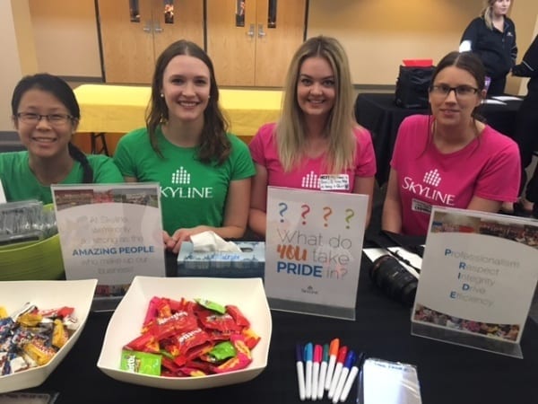 Four young Skyline employees run a booth about Skyline at the Power of Being a Girl event