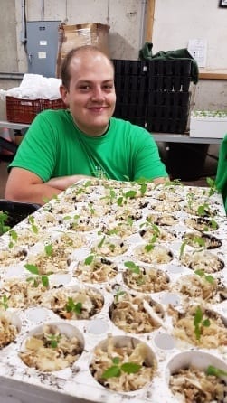 Kevin Corrigan poses with freshly planted tree saplings