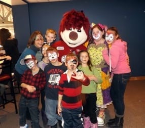 Storm mascott stands with children