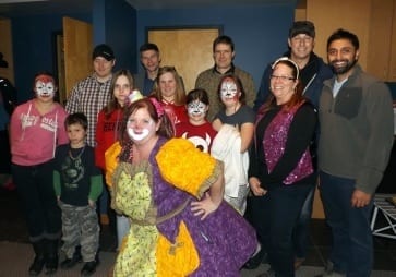 Cleo the Clown poses with Little Sisters and Little Brothers at the charity event
