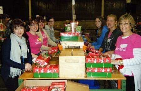 Seven Skyliners pack boxes for Operation Christmas Child
