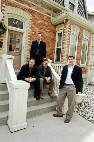 Four Skyline owners pose or a picture on the steps of an historic building