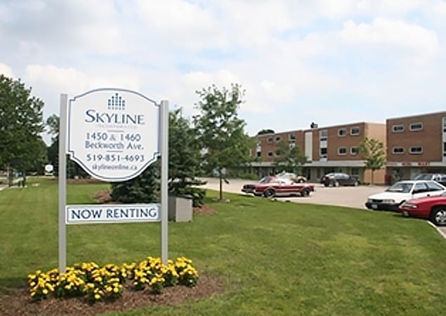 Sign for Beckworth Apartments standing on a large green lawn overlooking a three storey apartment complex