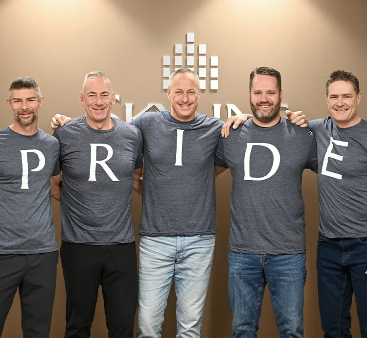 Skyliners wearing t-shirts that spell out P.R.I.D.E.